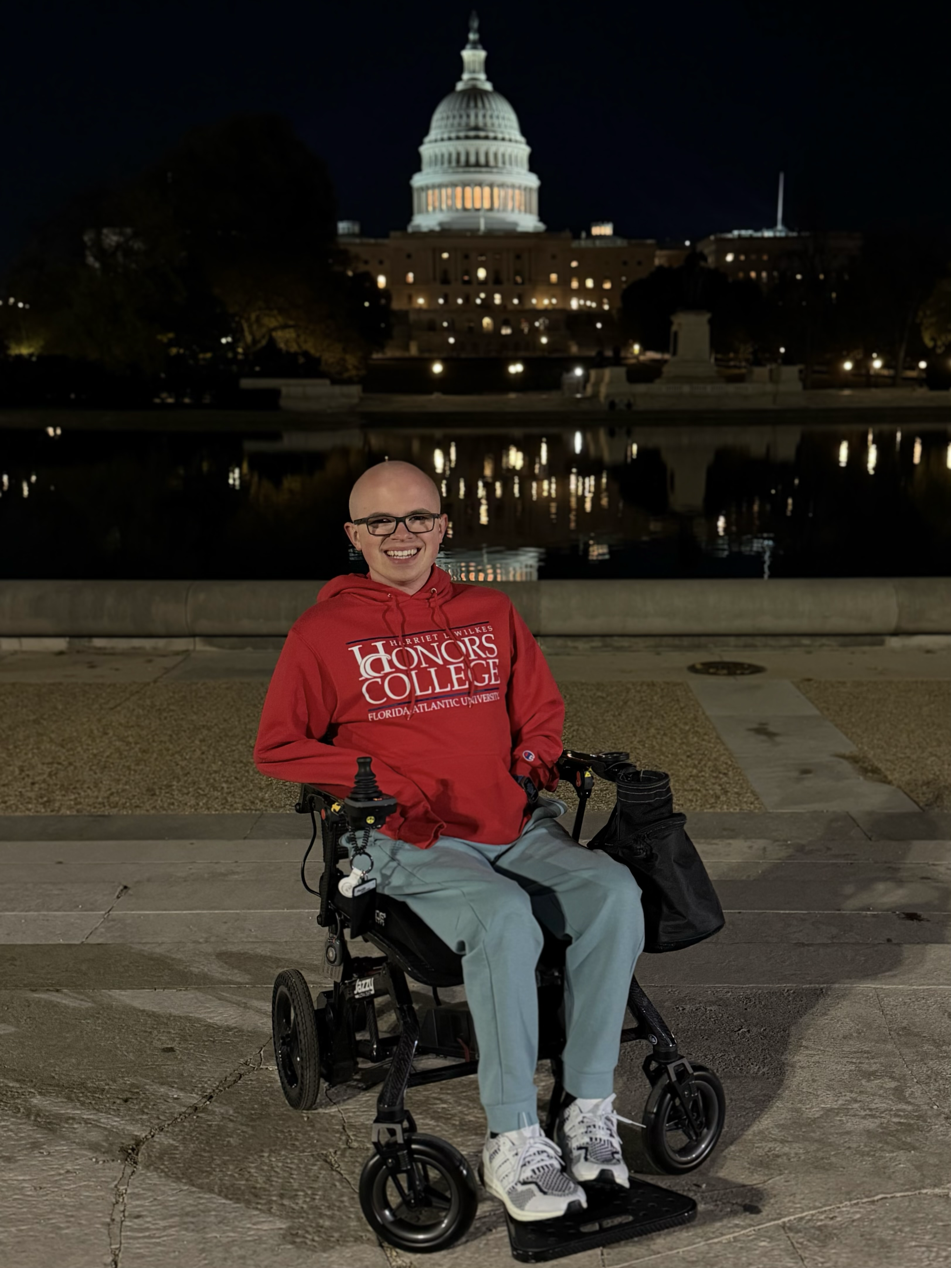 A power wheelchair joystick snapped and taped back together after air travel damage.