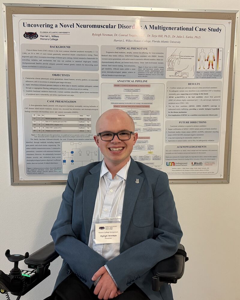 Ryleigh Newman in a blazer beside his research poster at the Wilkes Honors College Symposium, wearing a presenter badge.
