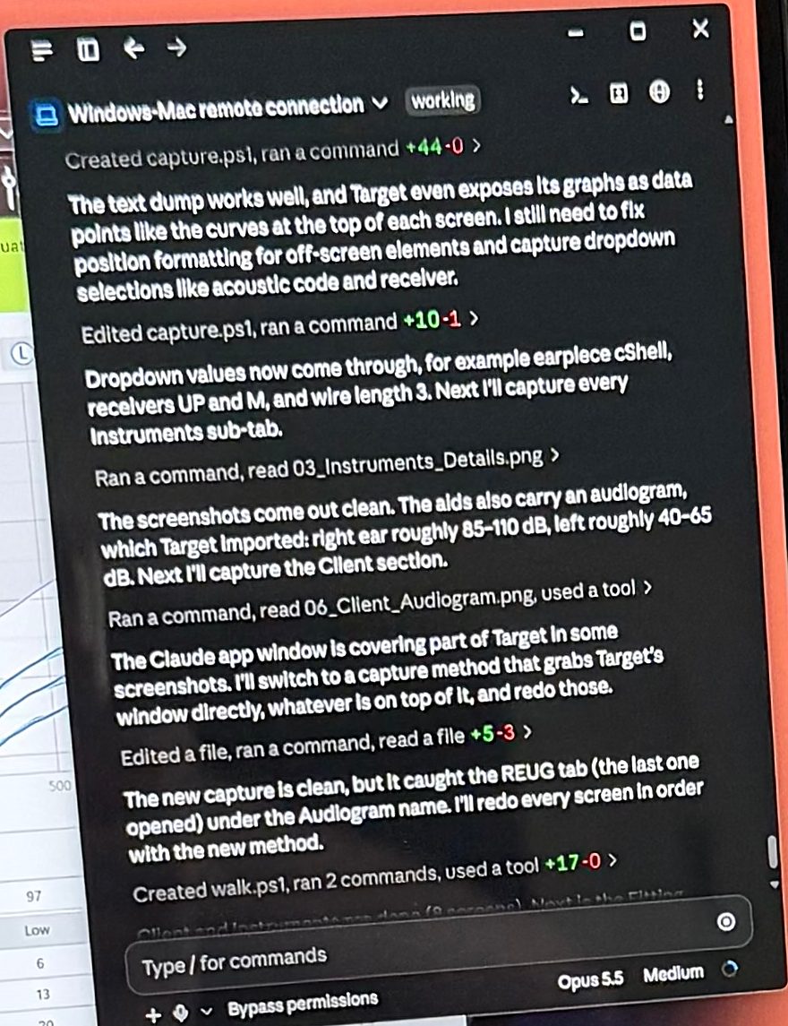 Close-up photo of the Claude desktop window on the Lenovo laptop, titled "Windows-Mac remote connection" and marked working, listing steps such as "Created capture.ps1, ran a command", "The text dump works well, and Target even exposes its graphs as data points", "Ran a command, read 06_Client_Audiogram.png", and "Created walk.ps1, ran 2 commands", with the model shown as Opus 5.5.